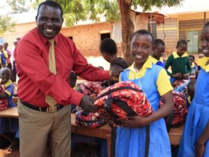 Grade 6 Girl from Ndiuni Primary School Receiving School Bag